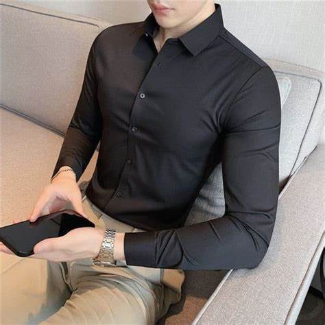 Front view of a man wearing a black Plus Size 4XL-M High Elasticity Seamless Long Sleeve Shirt, showcasing its slim-fit design.